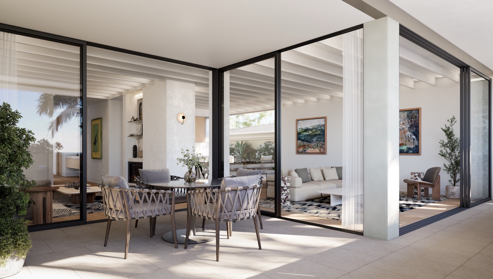 Open-plan living and dining area opening onto a shaded terrace